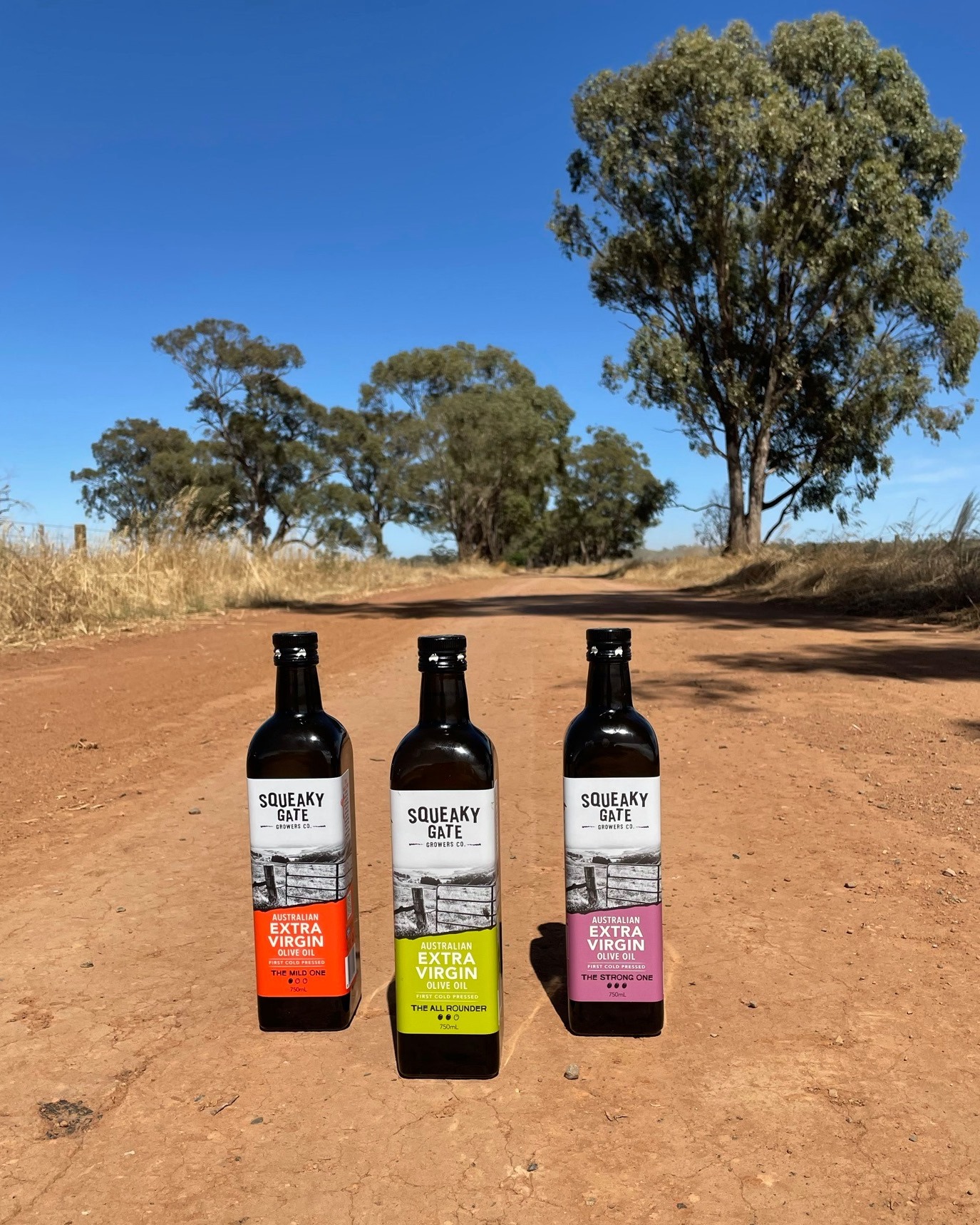 Squeaky Gate olive oil bottles on dirt road